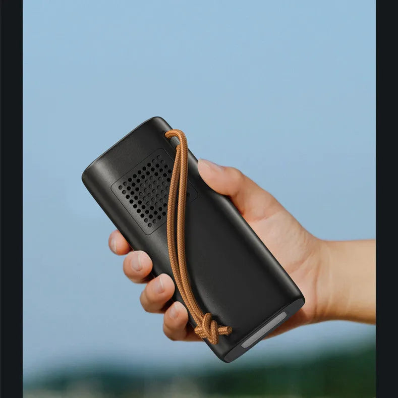 Black portable power bank with solar panel and display, showing 200W output and charging ports.