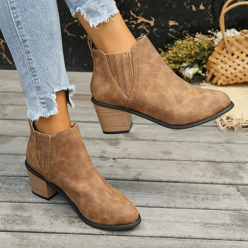 Women's black pointed toe ankle boots with thick square heel and slip-on design