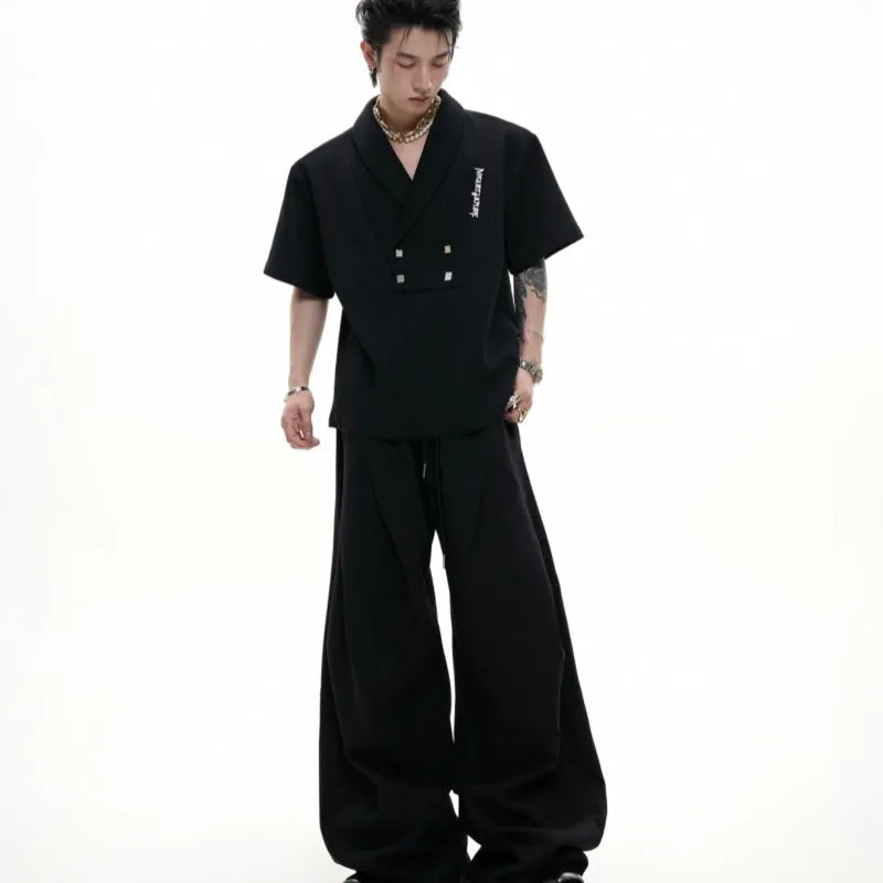 Men's dark grey cotton V-neck sports suit with padded shoulders, metal details, and matching shorts.