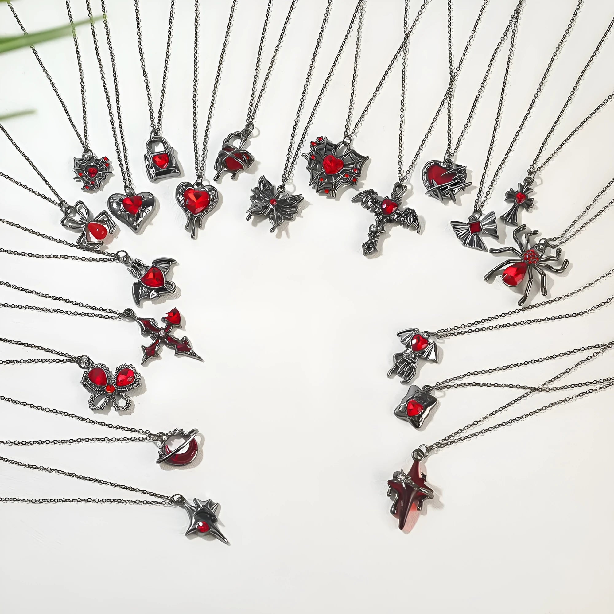 Close-up of a dark electroplated zinc alloy Halloween necklace pendant featuring a spider and bat design on a regular chain.