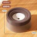 Green raised pet suspension bowl for dogs and cats on a white plate.