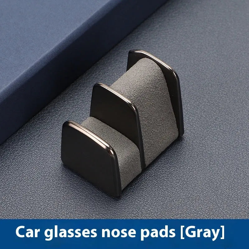 Zinc alloy and leather sunglasses clip holder for car dashboard in black, grey, green, or red.