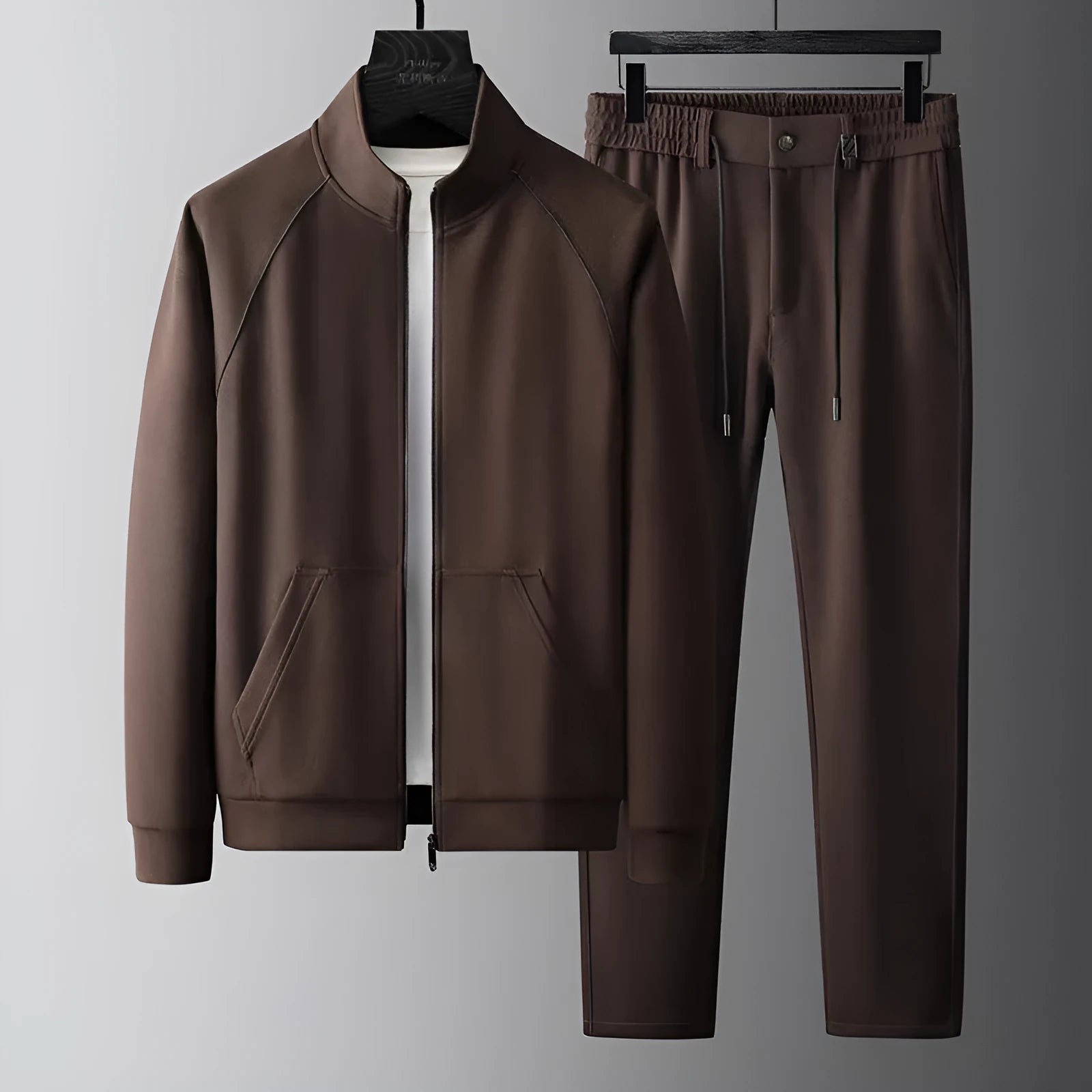 Stand collar casual sports suit comprising a coat and trousers in a slim fit, shown in coffee colour.