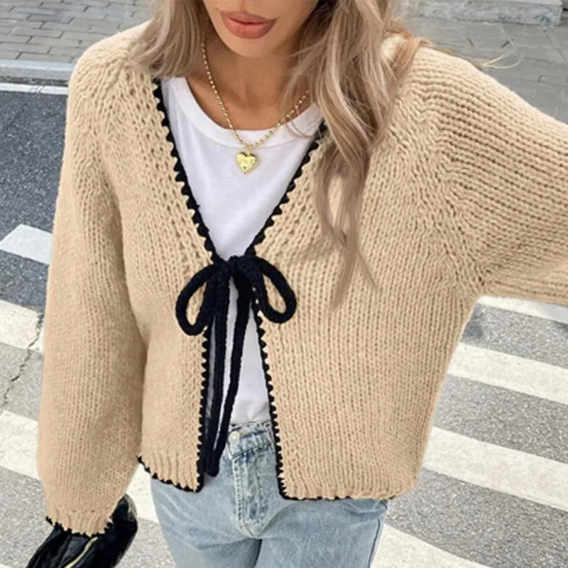 Grey lace-up cardigan with crocheted flower details and loose long sleeves