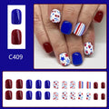 Short glossy false nails with strawberry cherry independence day patterns in red and blue