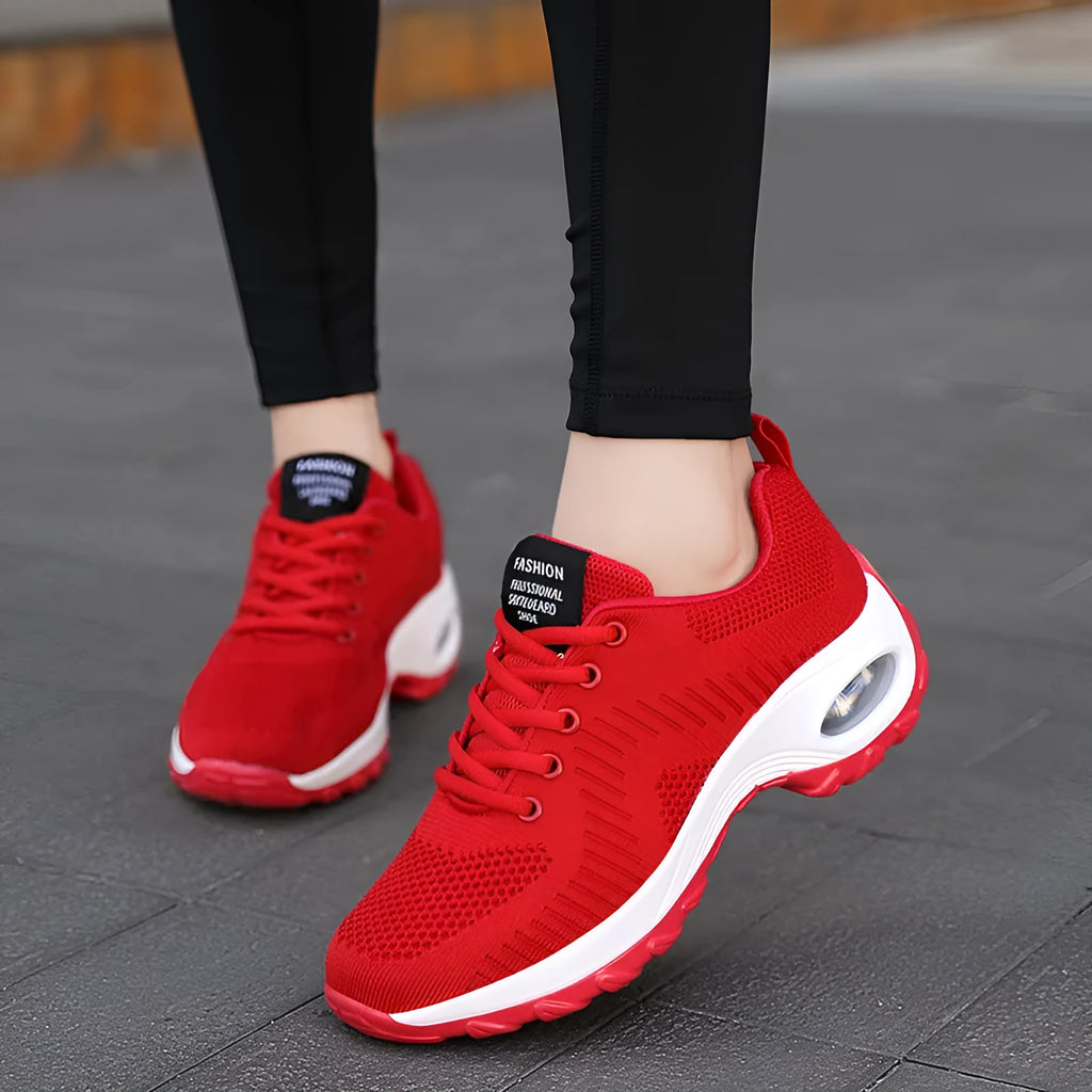 Red and black women's low-top mesh sneakers with round toe and front lace-up.
