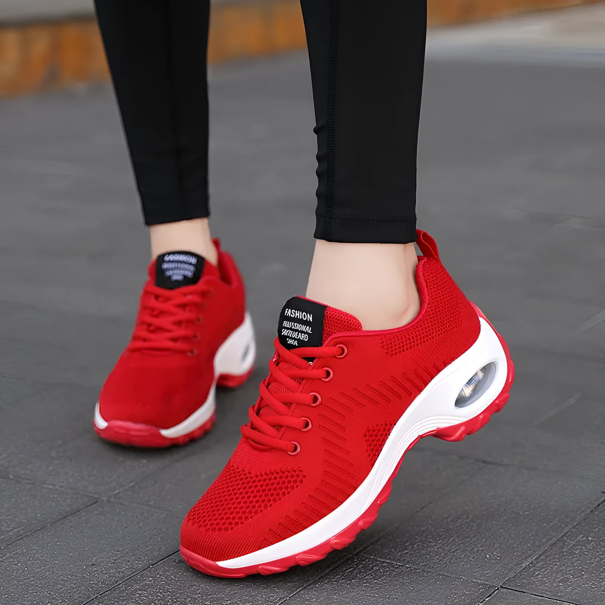 Red and black women's low-top mesh sneakers with round toe and front lace-up.