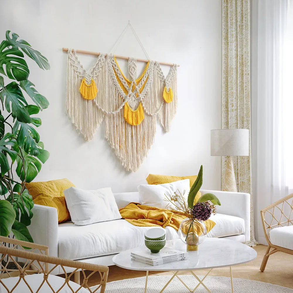 Hand-woven creamy white and yellow Nordic style cotton tapestry hanging on a wall