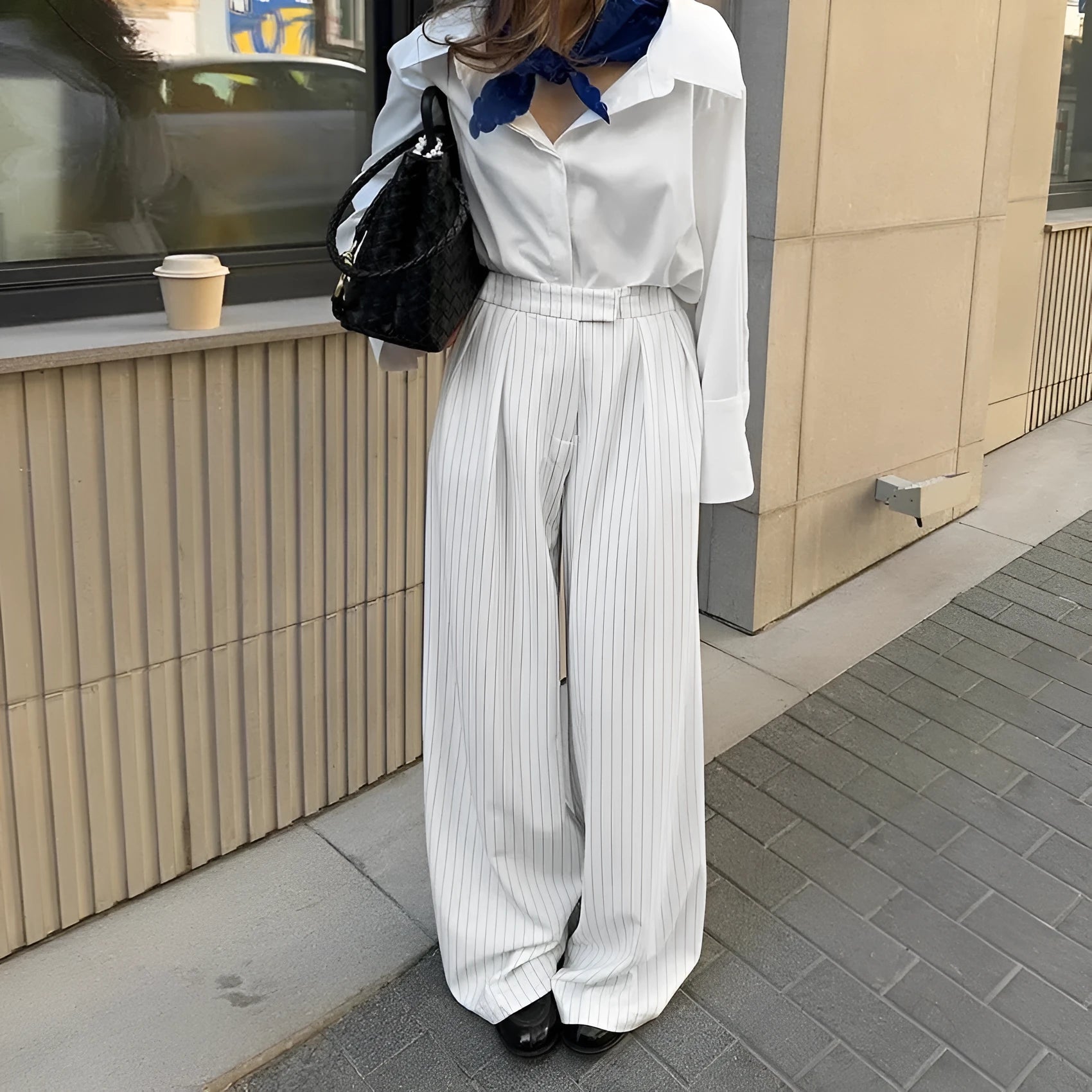 White striped wide-leg loose fit trousers with zipper front on a hanger