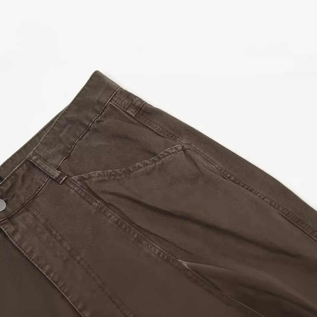 Men's brown loose fit straight leg cotton jeans with a high waist and zip fly on a hanger.