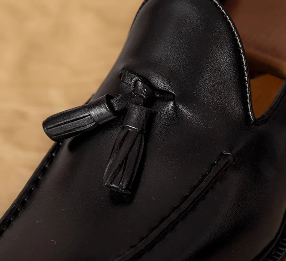 Men's black genuine leather loafers with fringed detail, rubber sole, and slip-on design