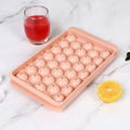 Blue silicone ice cube tray with 33 round cavities and clear snap-on lid