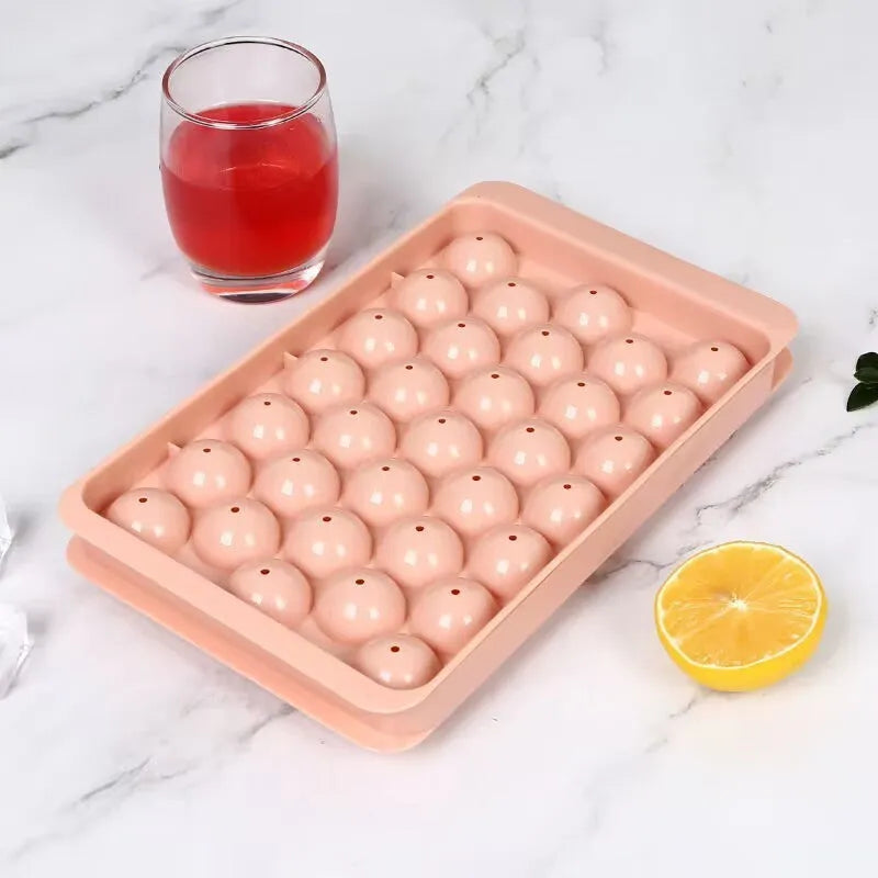 Blue silicone ice cube tray with 33 round cavities and clear snap-on lid