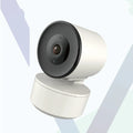 Indoor smart Wi‑Fi security camera with pan‑tilt base on a desk.