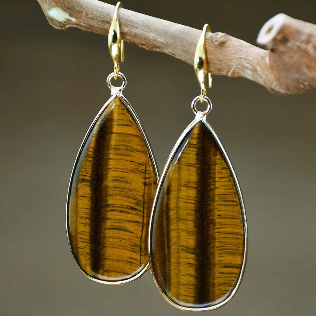 Vintage long drop earrings made from stone with a water droplet texture, shown in Tigereye colour.