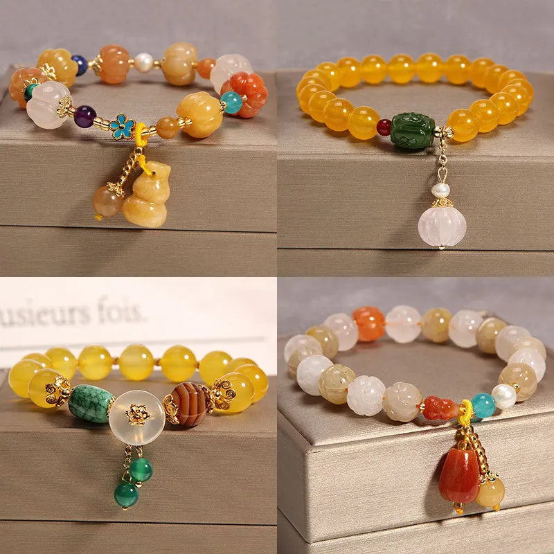 Women's yellow agate crystal beaded bracelet with gold silk thread and tassel.