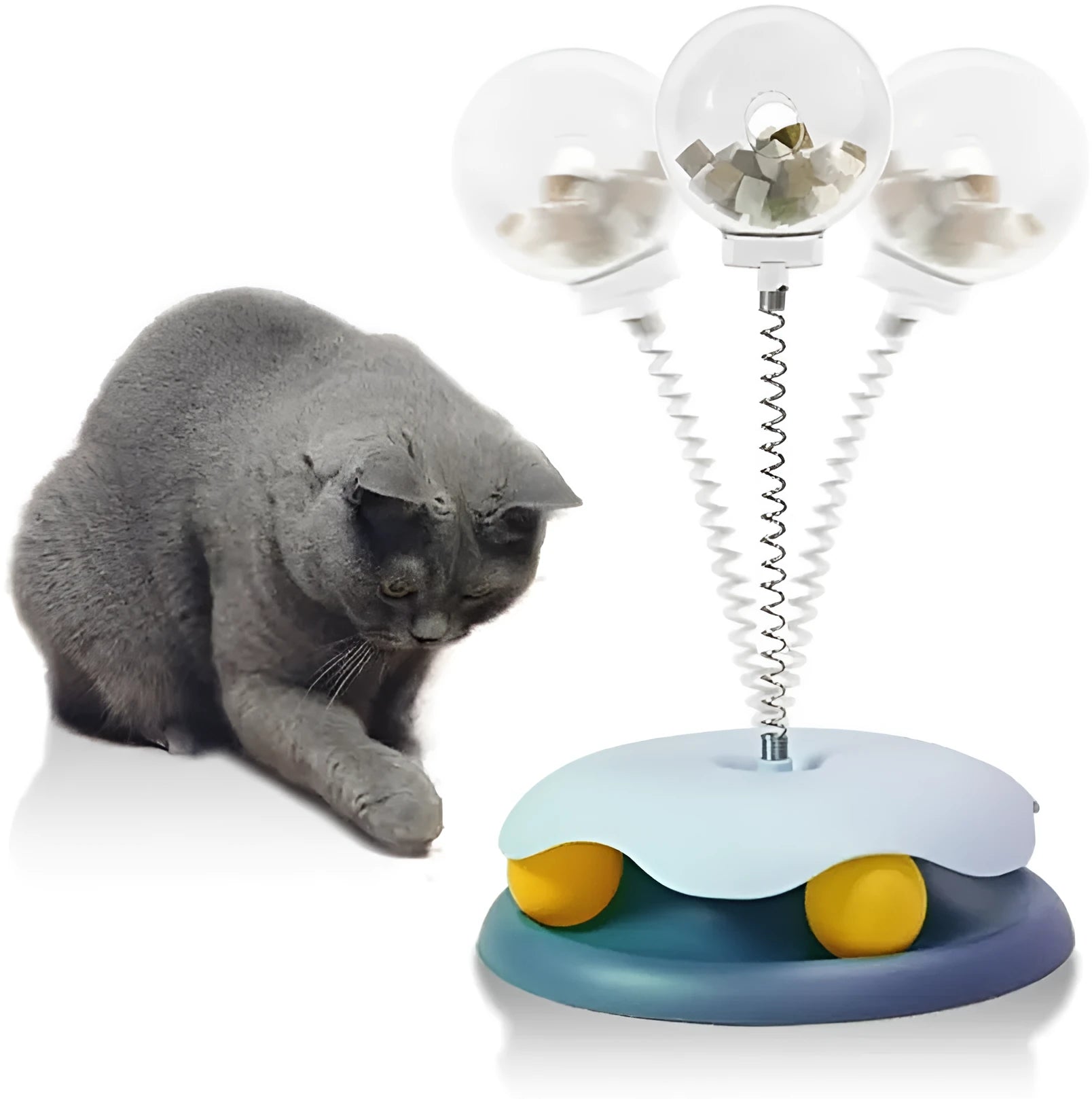 Blue and green interactive cat treat dispenser toy with track ball on flat surface