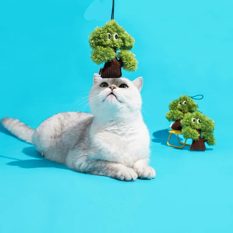 Pine tree-shaped hanging cat chew toy with mint filling, shown next to a ruler for scale