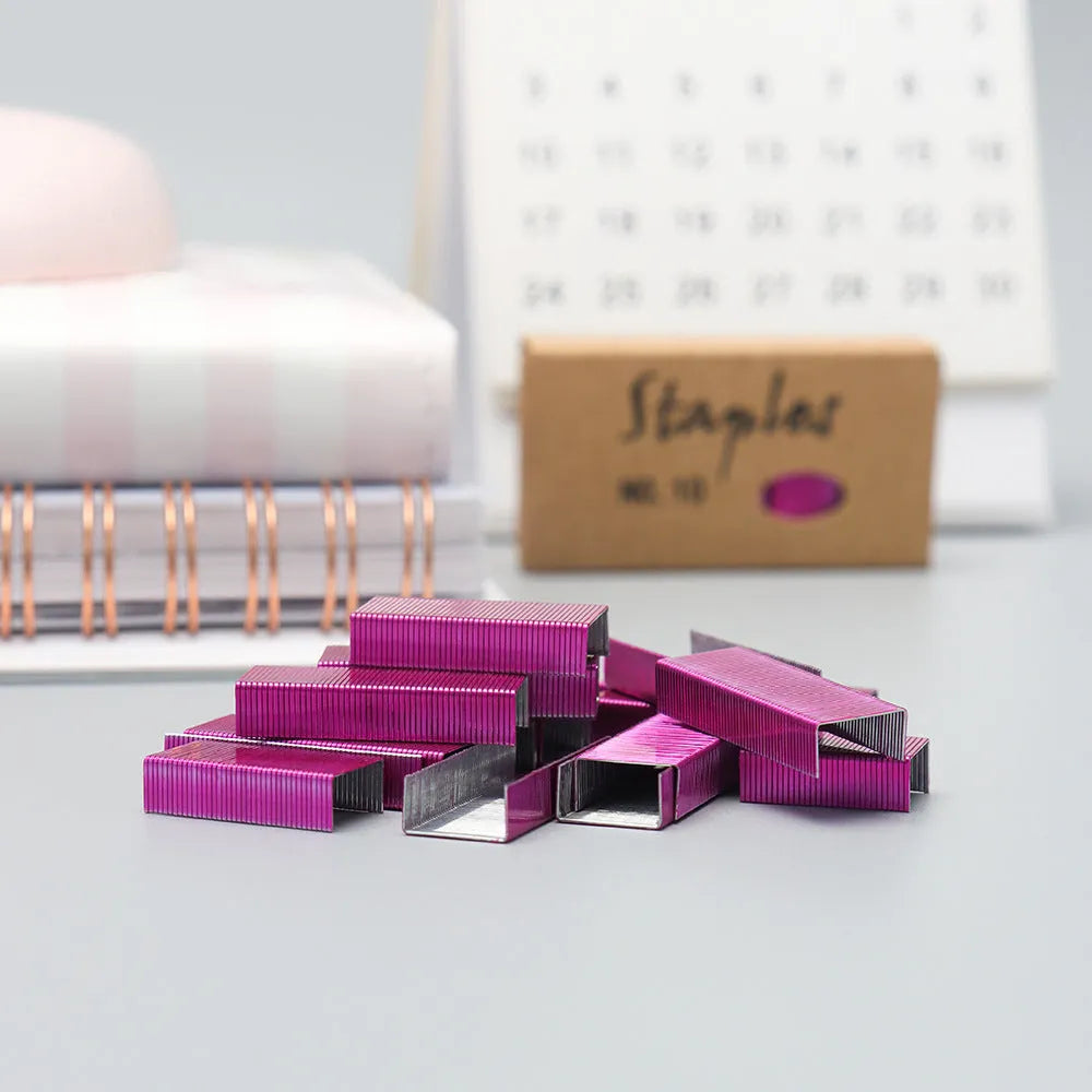 Box of 1000 metal office staples in rose gold, black, purple, and rose red colours.