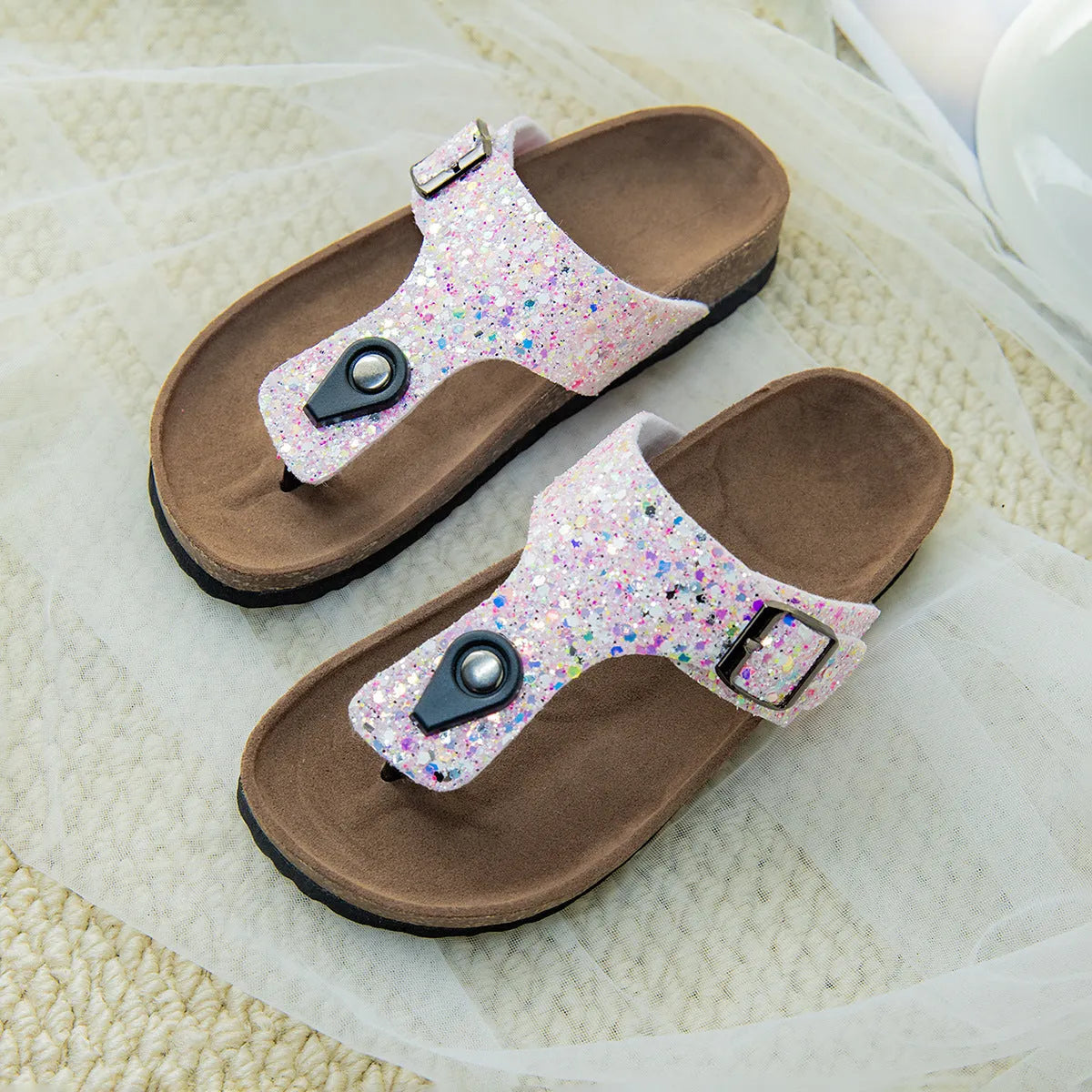 Children's cork flip-flops in gold with a hollow-out design and PVC sole.