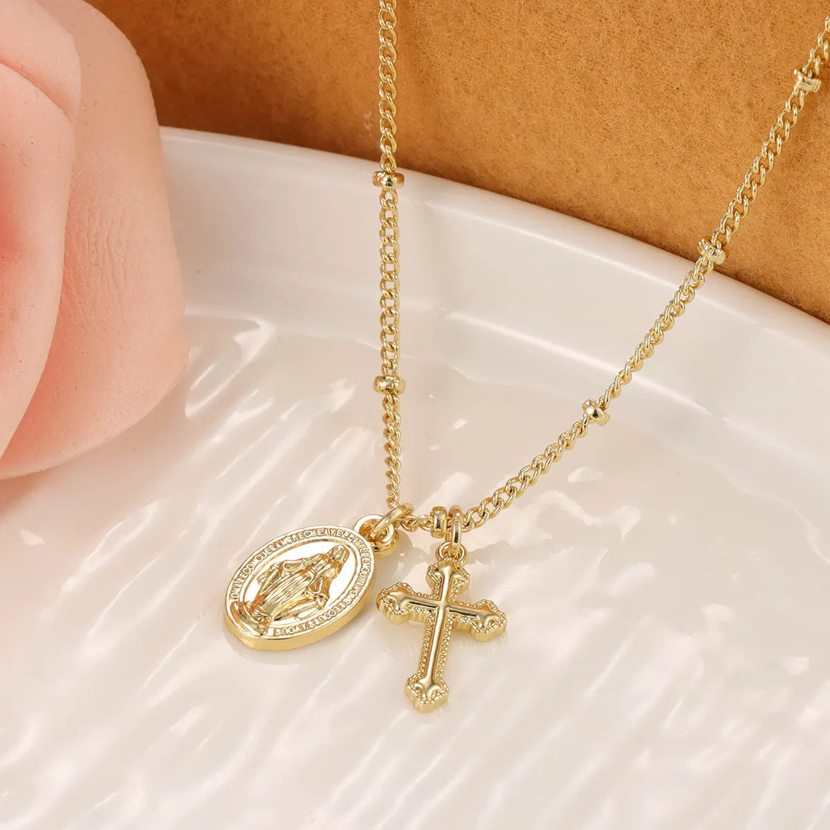 Gold geometric cross Virgin Mary necklace for women on a chain.