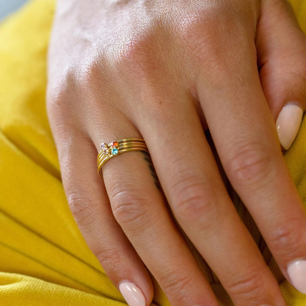 December birthstone titanium steel ring with geometric engraving, shown in gold and stone colours.