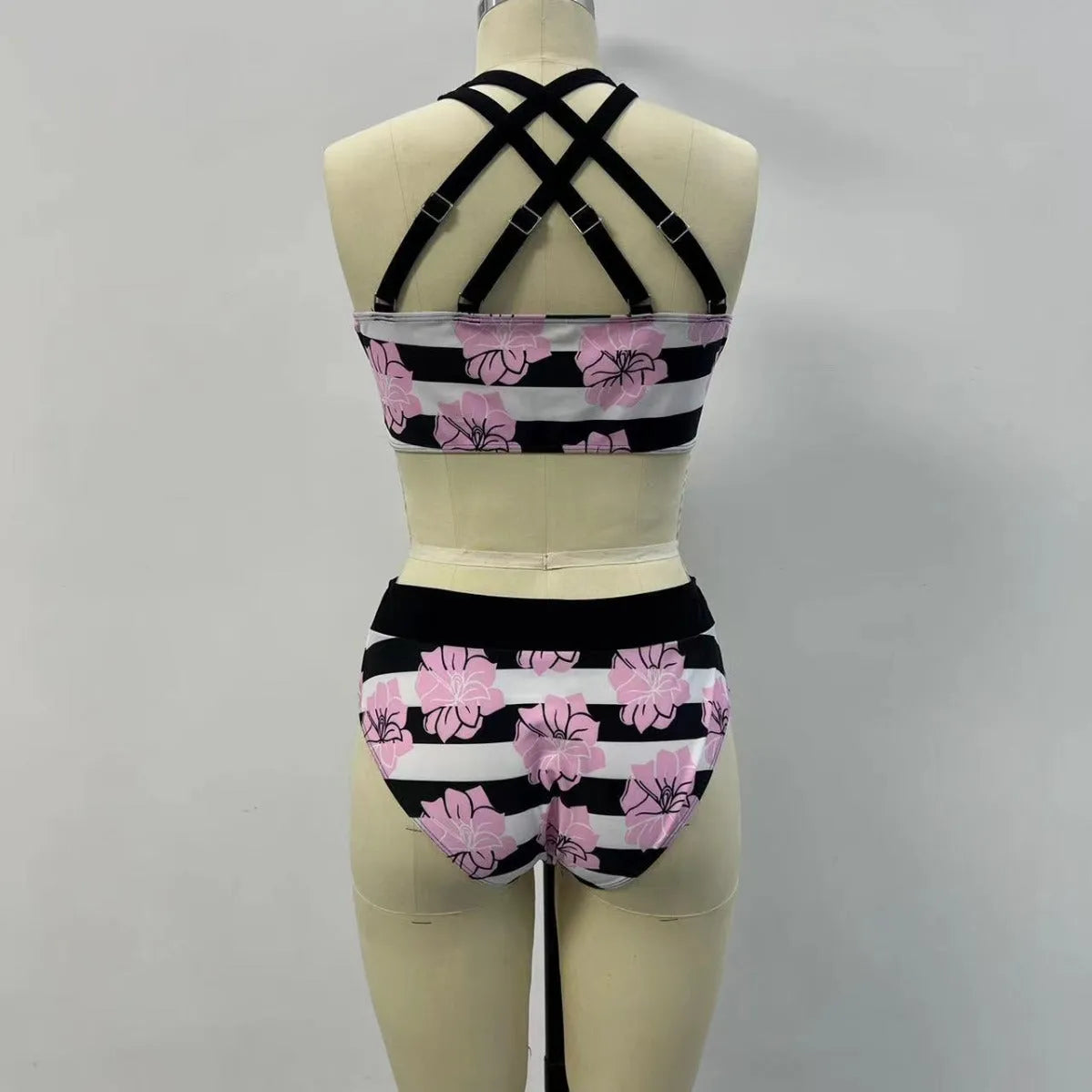 Black printed women's bikini with slimming belly panel and split-leg bottoms.