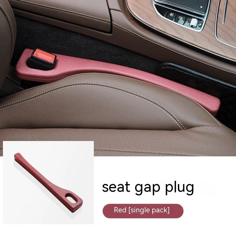Black polyurethane car seat gap filler strip preventing items falling between vehicle seats