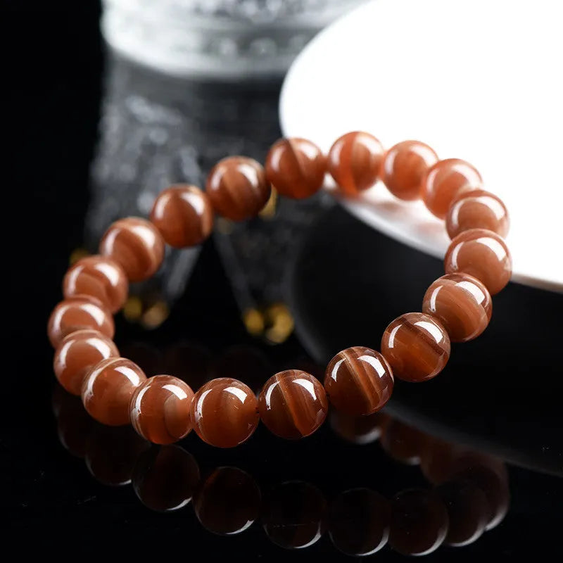 Natural old mine rhodochrosite round bead bracelet with ruyi elements, available in 6mm or 8mm bead sizes.