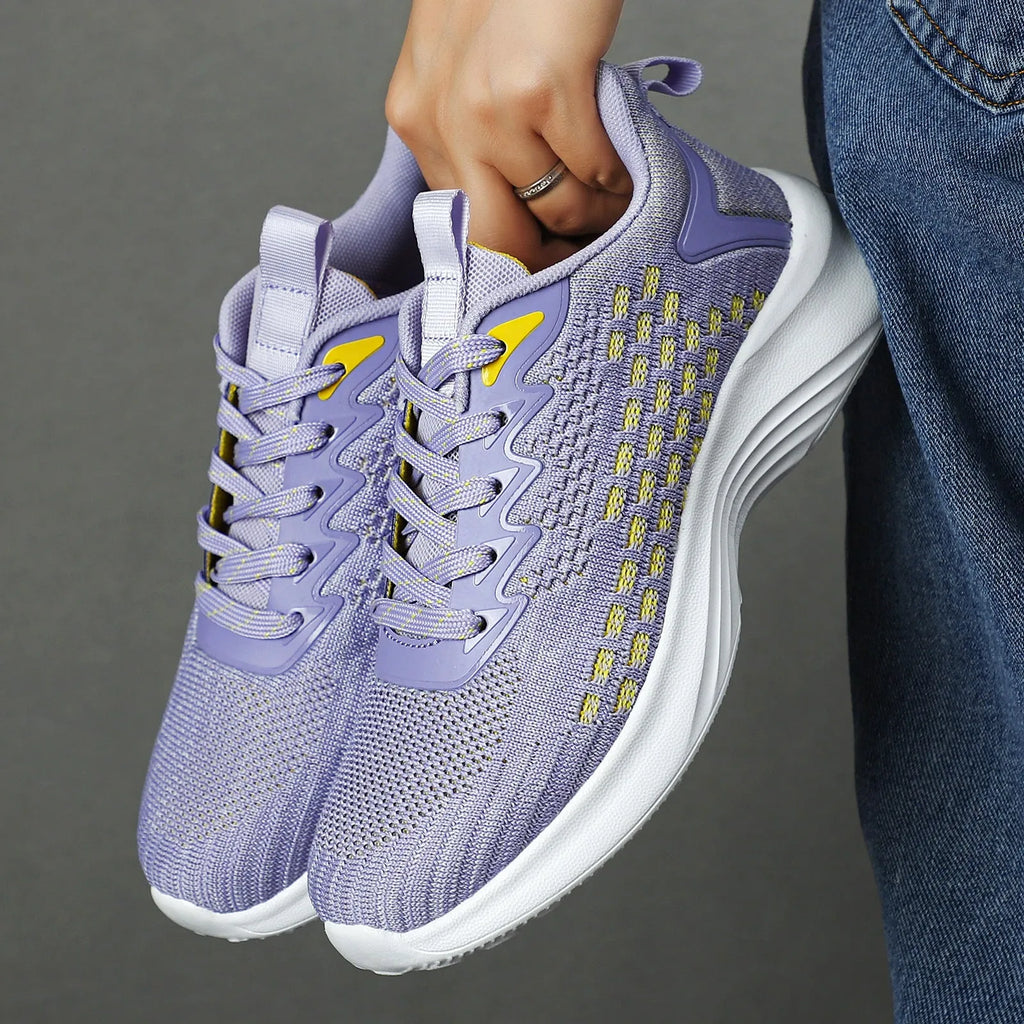 Women's lavender purple Flyknit running shoes with mesh lining and striped pattern for athletic use