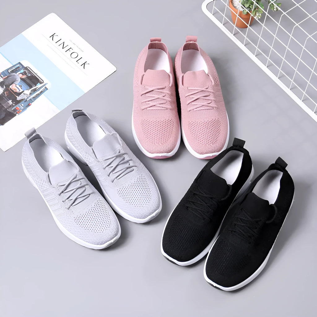 Women's black mesh sneakers with a round toe, front lace-up, and soft PVC sole.