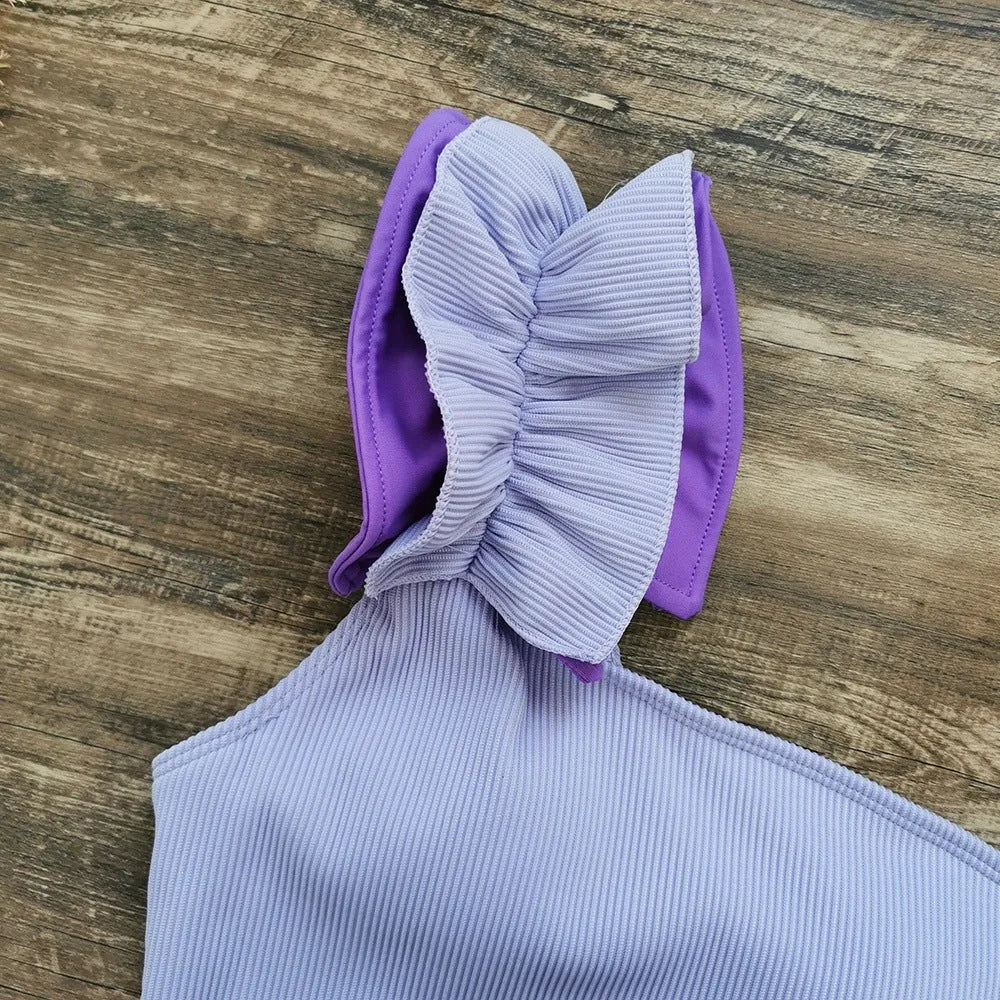 Women's single-shoulder high waist one-piece swimsuit in solid colour on a mannequin.