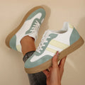 Green retro sports women's pumps with cross-strap design and round toe