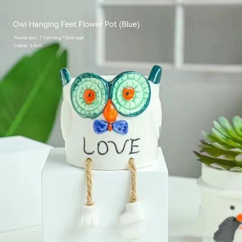 Ceramic cartoon-style succulent flowerpot with hanging foot design on desktop
