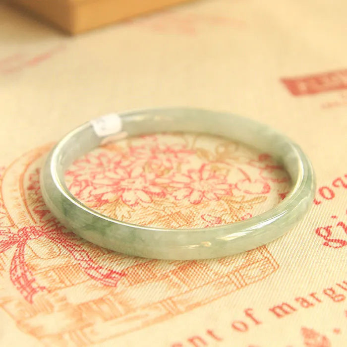 Green waxy jade geometric bracelet with Chinese-style design showing size measurement options