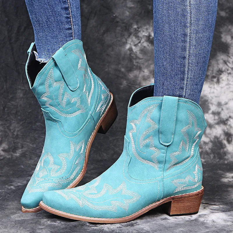 Women's blue embroidered cowboy boots with low chunky heel and pointed toe.