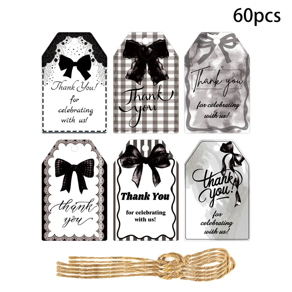 Set of 60 paper birthday gift tags with bowknot designs and natural hemp rope.
