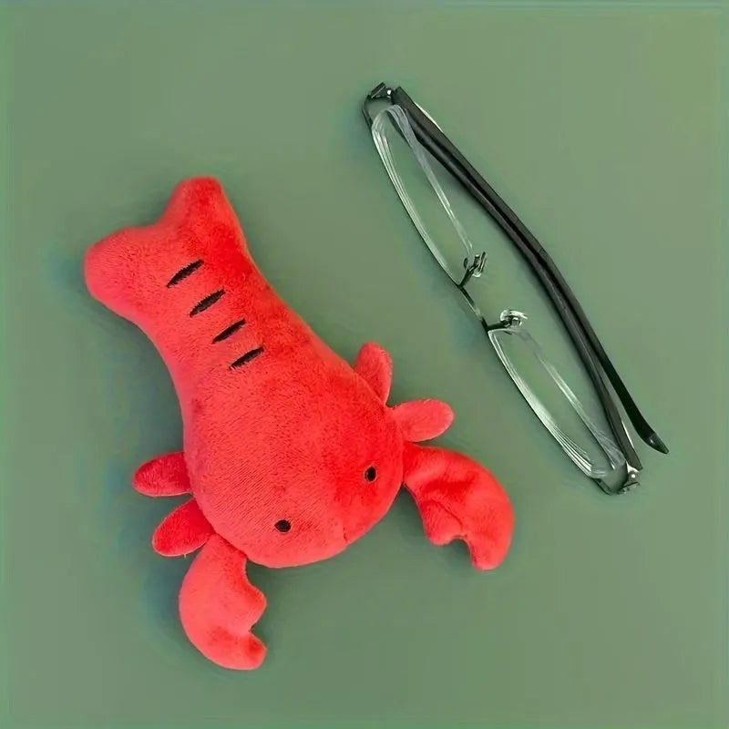 Red lobster shaped squeaky dog toy with soft plush material measuring 12.5cm length