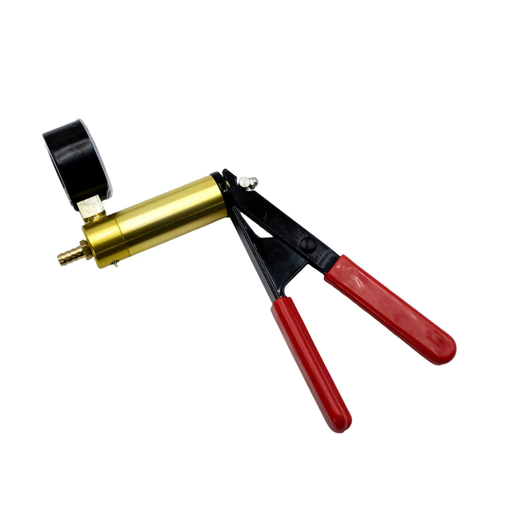 Aluminium manual vacuum air blow gun and suction tool for automotive repair on a workshop bench.