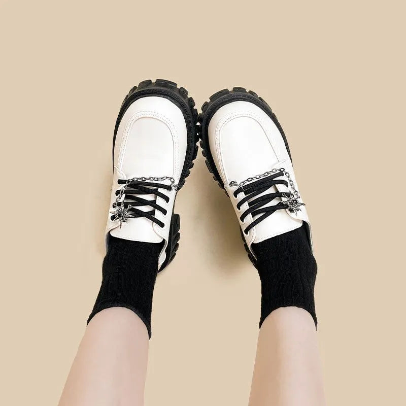 Women's preppy style loafers in Duke Asterism colour with metal cross shoulder strap and round toe
