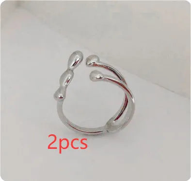 Brass adjustable fashion ring with spherical detail in gold or silver finish.