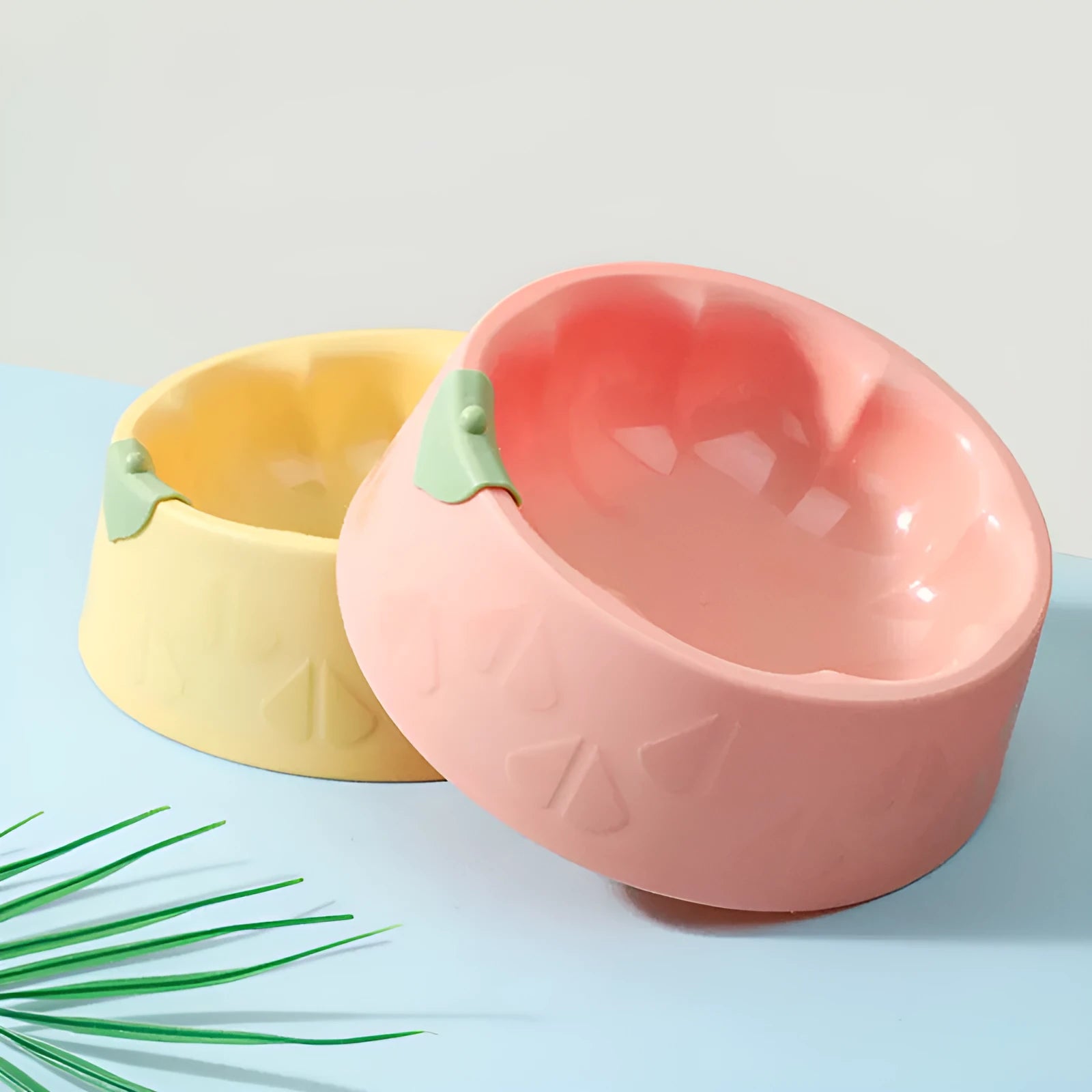Green plastic double bowl for dog and cat food and water with anti-tip base.