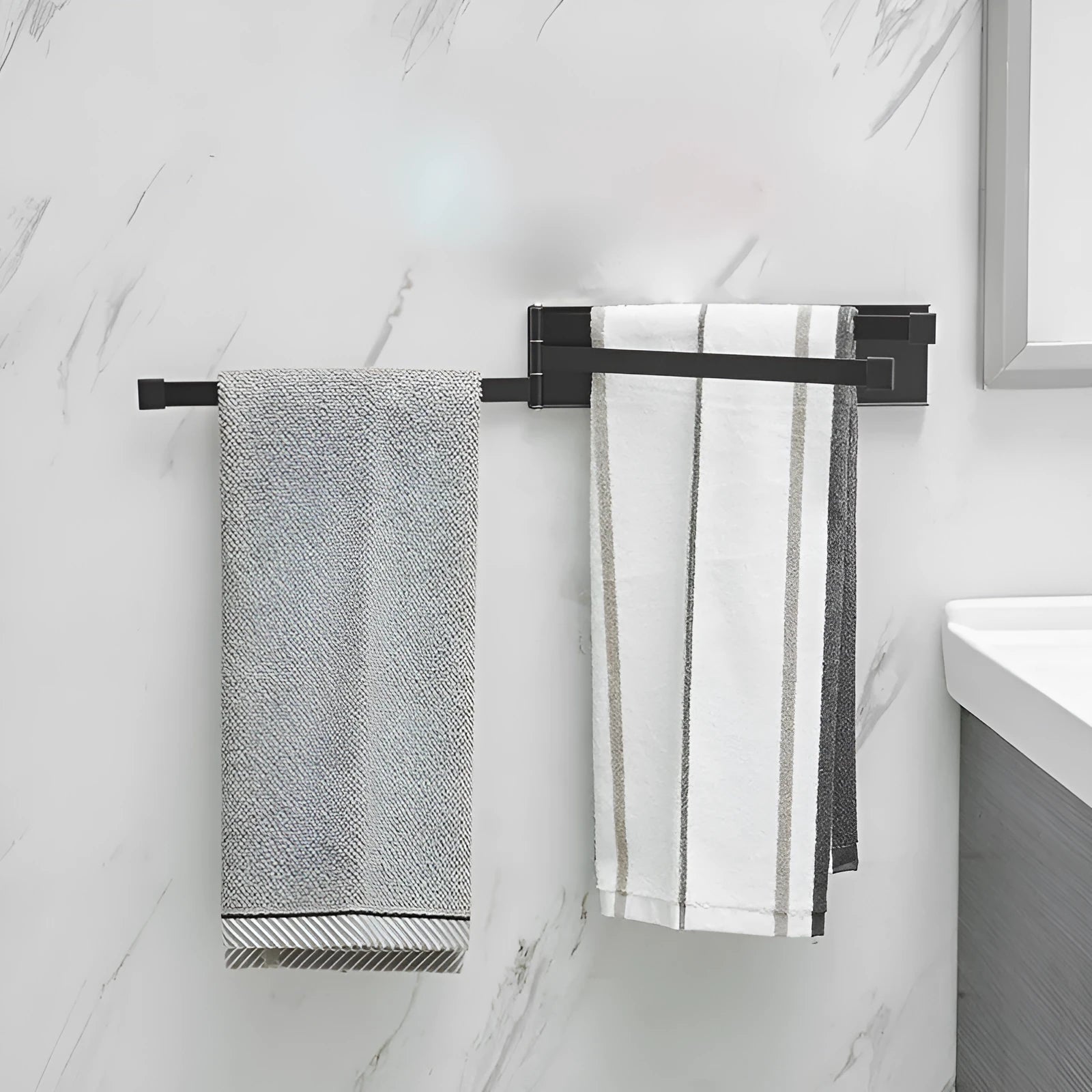 Nordic style black folding towel rack mounted on a white bathroom tile wall.