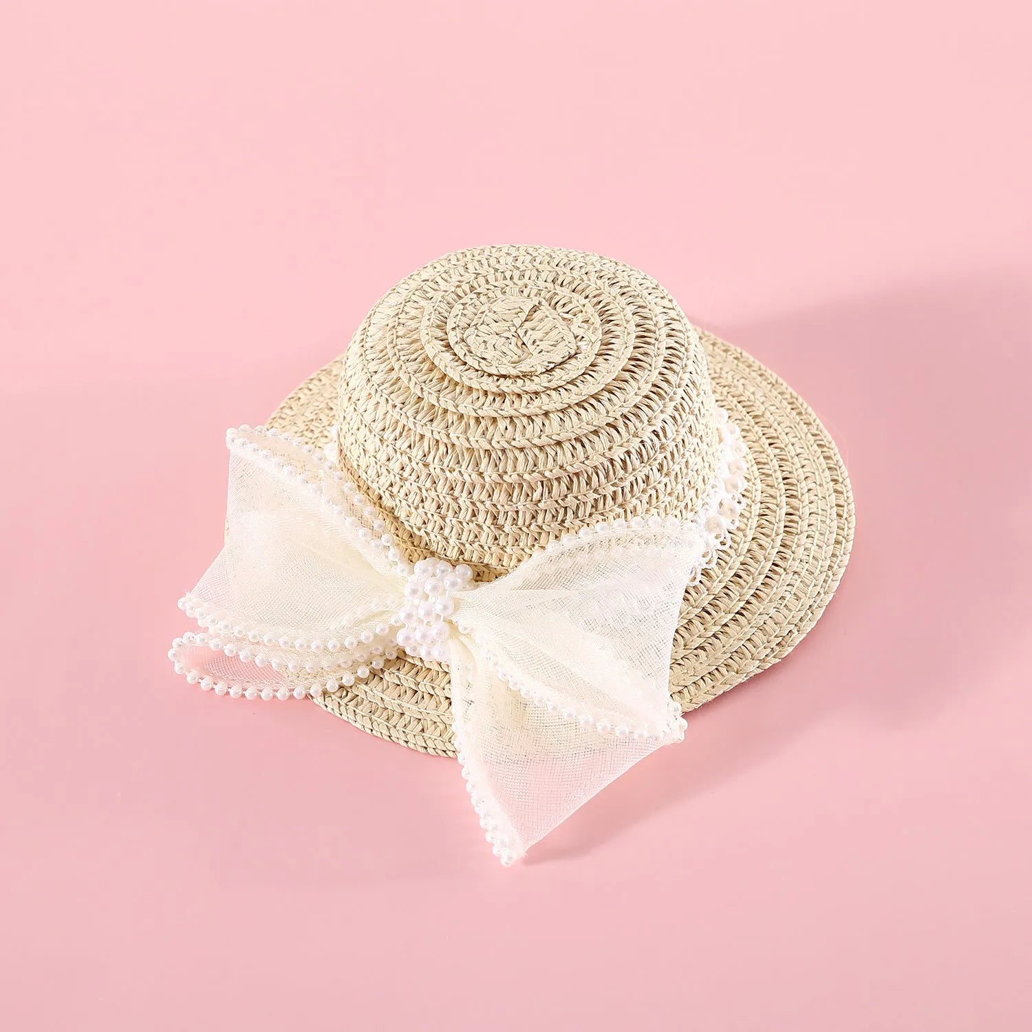 Cat wearing a woven Lafite leaves straw hat with a blue pearl butterfly bow.