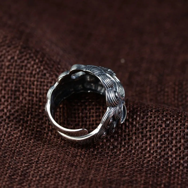 Silver open style ring with a detailed jibeast animal zodiac pattern.