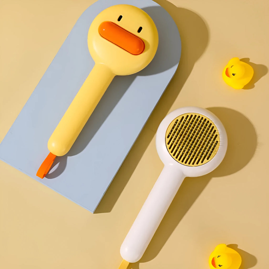 Small yellow duck-shaped pet grooming comb with stainless steel needles