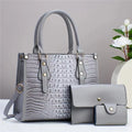 Women's contrast colour minimalist textured three-piece bag set showing crossbody bag, wallet and card holder in PU material