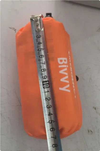 Emergency disaster relief tent kit with orange sleeping bag and whistle survival gear