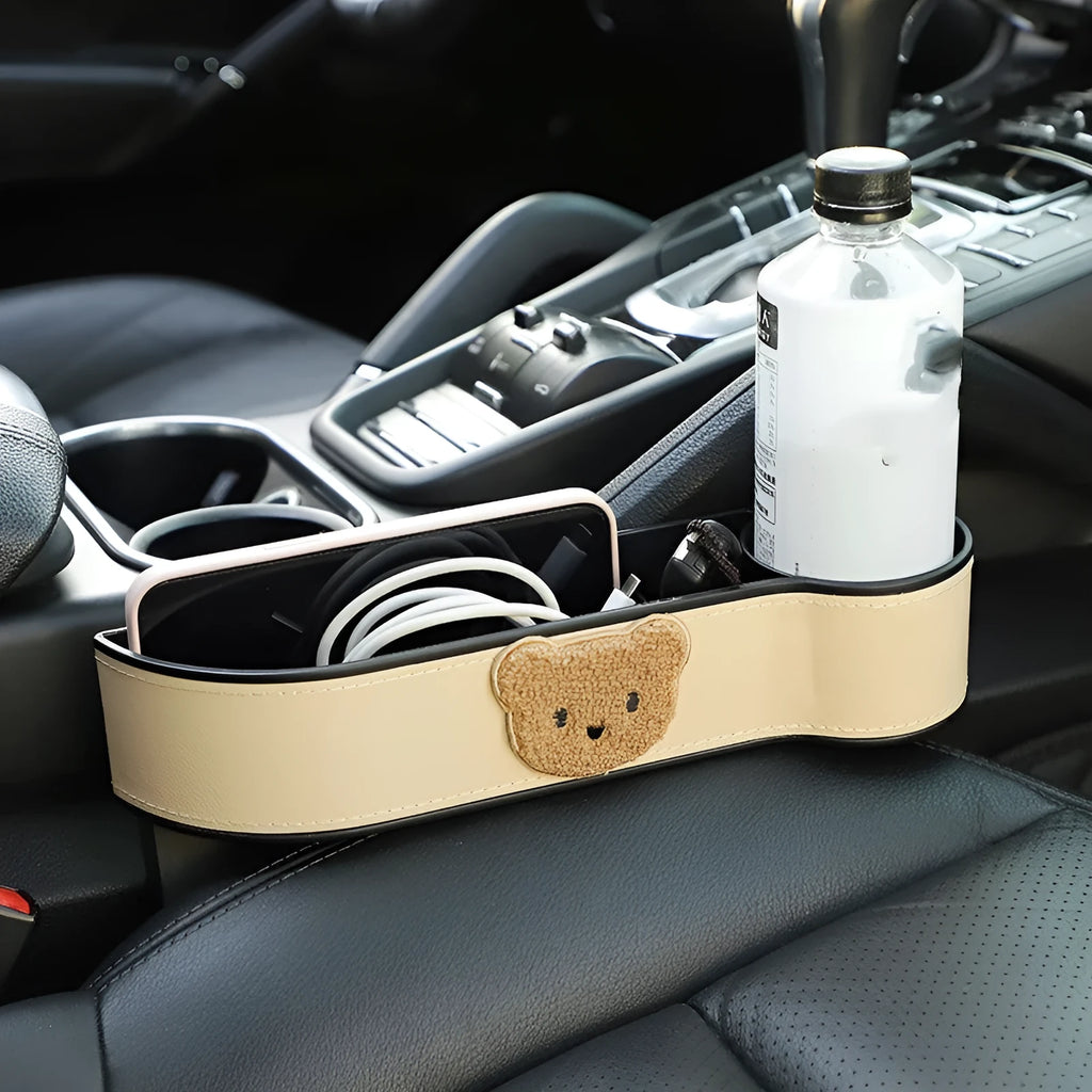 Leather car seat gap storage box with cartoon bear design for organising phones and keys.