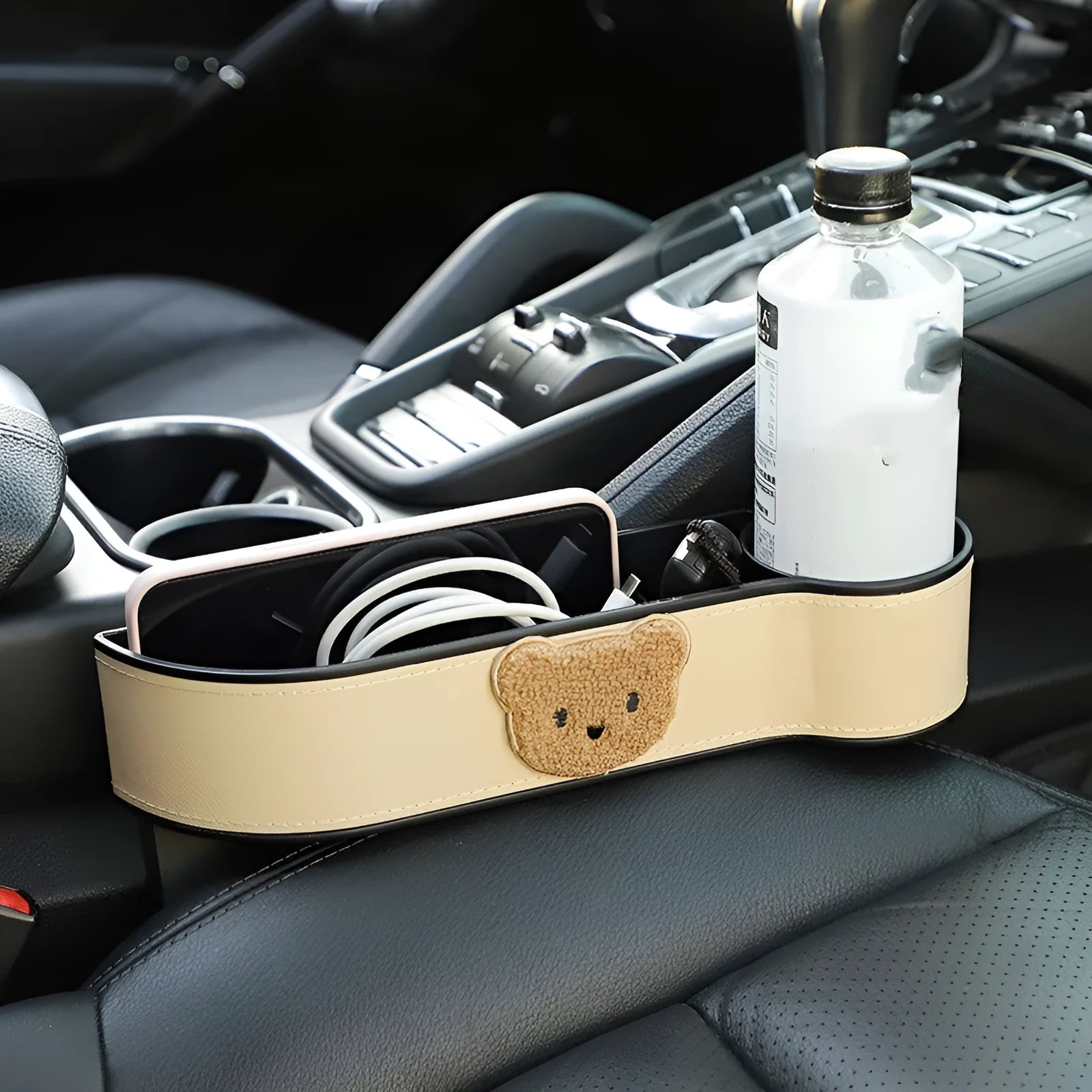 Leather car seat gap storage box with cartoon bear design for organising phones and keys.